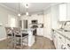 Modern kitchen features white cabinets, granite countertops, stainless steel appliances, and a convenient island with bar seating at 363 Bellingrath Blvd, Rock Hill, SC 29730
