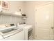 Bright laundry room with washer, dryer, and storage shelf at 363 Bellingrath Blvd, Rock Hill, SC 29730
