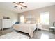 Bright bedroom featuring a ceiling fan, two windows, and hardwood floors, creating a welcoming and comfortable space at 363 Bellingrath Blvd, Rock Hill, SC 29730