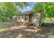 Exterior view of a home featuring siding, a covered porch, and a generously sized backyard space at 3924 Tillman Rd, Charlotte, NC 28208
