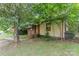 A charming bungalow-style home with a brick and siding exterior and mature trees at 3924 Tillman Rd, Charlotte, NC 28208