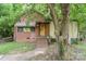 Charming bungalow with brick and siding, featuring a covered porch and mature trees at 3924 Tillman Rd, Charlotte, NC 28208