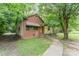 A single story home with a brick and siding exterior and mature trees in the front yard at 3924 Tillman Rd, Charlotte, NC 28208