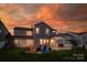 A backyard with seating area and playset, perfect for outdoor entertainment and relaxation at sunset at 4023 Spring Garden St, Fort Mill, SC 29715
