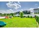 Landscaped backyard featuring a spacious lawn, privacy fence, and colorful Adirondack chairs at 4023 Spring Garden St, Fort Mill, SC 29715