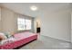 Simple bedroom with bright natural light and neutral colored walls at 4023 Spring Garden St, Fort Mill, SC 29715