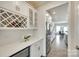 Butler pantry showcasing wine storage, white cabinetry, quartz counters, and stainless steel mini refrigerator at 4023 Spring Garden St, Fort Mill, SC 29715
