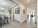 Elegant dining room with wainscoting, modern lighting, and an open layout flowing into the kitchen at 4023 Spring Garden St, Fort Mill, SC 29715
