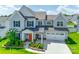 Beautiful two-story home featuring a manicured lawn, attached two car garage, and a covered front porch at 4023 Spring Garden St, Fort Mill, SC 29715