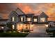 Charming two-story home featuring a manicured lawn, attached two car garage, and a covered front porch at 4023 Spring Garden St, Fort Mill, SC 29715