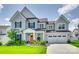 Beautiful two-story home featuring a manicured lawn, inviting front porch, and two car garage at 4023 Spring Garden St, Fort Mill, SC 29715