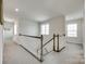 Bright hallway features natural light, a stair case, and neutral carpet at 4023 Spring Garden St, Fort Mill, SC 29715