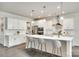 Bright open kitchen featuring white cabinets, stainless steel appliances, a center island, and pendant lighting at 4023 Spring Garden St, Fort Mill, SC 29715