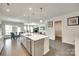 Open concept kitchen with a large island, stainless steel sink, and views into the living space at 4023 Spring Garden St, Fort Mill, SC 29715