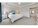 Comfortable main bedroom featuring a tray ceiling, a large bed and bright natural light at 4023 Spring Garden St, Fort Mill, SC 29715