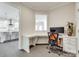 Bright office space with a built-in desk, storage, and view into the kitchen at 4023 Spring Garden St, Fort Mill, SC 29715