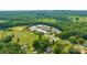 Aerial view of school buildings in a wooded area, with athletic fields and parking at 405 W Ormand Ave, Bessemer City, NC 28016