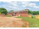 The back exterior of this home has a brick facade, small deck, and a fenced in yard at 405 W Ormand Ave, Bessemer City, NC 28016