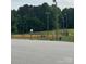 An empty baseball field with a covered dugout is surrounded by tall light posts at 405 W Ormand Ave, Bessemer City, NC 28016