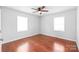 This bedroom features hardwood floors, neutral colored walls, and a modern ceiling fan at 405 W Ormand Ave, Bessemer City, NC 28016