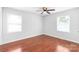 Bedroom with hardwood floors, ceiling fan, and natural light from two windows at 405 W Ormand Ave, Bessemer City, NC 28016