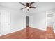 Bedroom featuring hardwood floors, ceiling fan, and ample closet space at 405 W Ormand Ave, Bessemer City, NC 28016