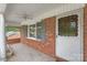 Cozy front porch with brick columns and a fan, offering a welcoming spot to relax and enjoy the outdoors at 405 W Ormand Ave, Bessemer City, NC 28016