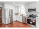 Updated kitchen with stainless steel appliances, white cabinets, and modern finishes at 405 W Ormand Ave, Bessemer City, NC 28016