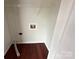 This is a quaint laundry room with hardwood floors, a wire rack, and a washing machine hookup at 405 W Ormand Ave, Bessemer City, NC 28016