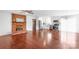 Open-concept living room and kitchen with hardwood floors, white cabinets and brick fireplace at 405 W Ormand Ave, Bessemer City, NC 28016