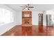 Inviting living room featuring hardwood floors, a brick fireplace, and a ceiling fan at 405 W Ormand Ave, Bessemer City, NC 28016