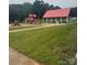 A park with playground equipment and a picnic shelter covered with a red metal roof at 405 W Ormand Ave, Bessemer City, NC 28016