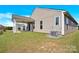 Spacious backyard with well-maintained lawn, complemented by a covered patio, and air conditioning condenser unit at 4243 Merrivale Dr, Lancaster, SC 29720