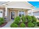 Inviting covered front porch with stone accents and lush landscaping creating a warm and welcoming entrance at 4243 Merrivale Dr, Lancaster, SC 29720