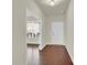 Hallway with hardwood floors, white trim, white front door and a view of another room at 4243 Merrivale Dr, Lancaster, SC 29720