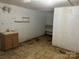 A partially renovated basement area with a sink, shelves, and access to another room at 4268 Wilkesboro Hwy, Statesville, NC 28625