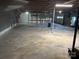 Unfinished basement space with concrete floor, exposed ceiling, and a door to a garage at 4268 Wilkesboro Hwy, Statesville, NC 28625