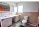 Functional bathroom featuring a double sink vanity and a standard toilet, ready for updates at 4268 Wilkesboro Hwy, Statesville, NC 28625