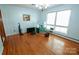 Sunny dining room with hardwood floors, large window, and classic chandelier fixture at 4268 Wilkesboro Hwy, Statesville, NC 28625