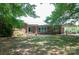 Charming brick home with mature trees and a covered carport offers a welcoming facade and ample outdoor space at 4268 Wilkesboro Hwy, Statesville, NC 28625
