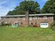 Brick home featuring backyard, garage and multiple windows, surrounded by a lush green lawn at 4268 Wilkesboro Hwy, Statesville, NC 28625