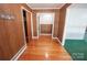Inviting hallway with hardwood floors and wood paneling, leading to other rooms in the home at 4268 Wilkesboro Hwy, Statesville, NC 28625