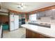 Well-lit kitchen features a breakfast bar, neutral countertops, and classic cabinets at 4268 Wilkesboro Hwy, Statesville, NC 28625