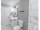 Contemporary bathroom features gray walls, white fixtures, and marble-look tiling for a clean, updated space at 4914 Ridgeley Dr, Charlotte, NC 28208