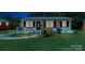 Inviting home exterior with neatly kept lawn and porch area, enhanced by surrounding greenery at 4914 Ridgeley Dr, Charlotte, NC 28208