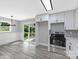 Bright kitchen with stainless steel appliances, white cabinets, herringbone backsplash, and modern light fixture at 4914 Ridgeley Dr, Charlotte, NC 28208