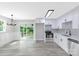 Eat-in kitchen with white cabinetry, stainless steel appliances, and gray wood-look floors at 4914 Ridgeley Dr, Charlotte, NC 28208