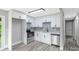 Bright kitchen with stainless steel appliances, white cabinets, and modern backsplash at 4914 Ridgeley Dr, Charlotte, NC 28208
