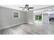 Bright living room with modern gray floors, neutral paint, ceiling fan, and views to the kitchen at 4914 Ridgeley Dr, Charlotte, NC 28208