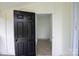Bright sunroom featuring white paneling, a dark accent door, and wood-look flooring at 4914 Ridgeley Dr, Charlotte, NC 28208